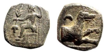 GREEK, Cilicia, 2nd century BC,  AR 10mm
Cilicia, uncertain, 2nd century BC. AR 10mm (0.62 gm). 
Obv.: Baaltars seated, resting on scepter, holding ear of corn and bunch of grapes. 
Rev.: Forepart of wolf; above, &#937;. 
Cf. SNG Levante 226.
