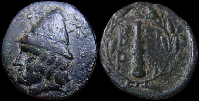 Troas, Birytis.  AE 18.  Kabeiros wearing pilos
4th cent BC. AE18 (4.80g). Head of beardless Kabeiros left, wearing pilos, flanked by stars / B-I/P-Y and club, all within laurel wreath. 
