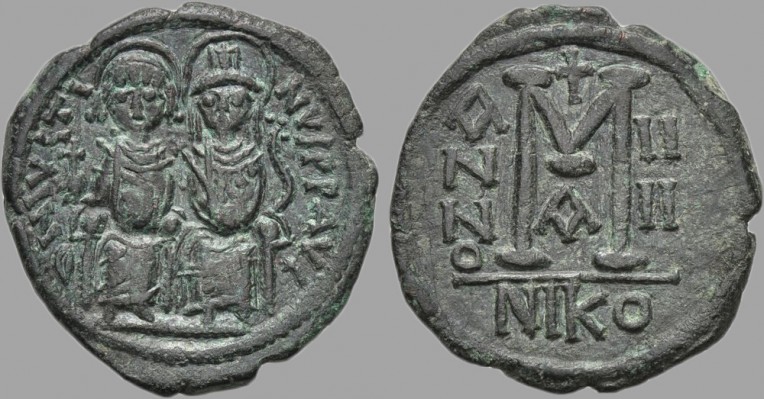 Byzantine Empire: Justin II (565-578) AE Follis, Nicomedia (Sear-369)
Obv: D N IVSTINVS P P AVG.
Justin, holding globus cruciger, and Sophia, holding cruciform scepter, seated facing on double throne, both crowned.
Rev: Large M between A/N/N/O and IIII; above, cross; beneath, A; in exergue, NIKO.

