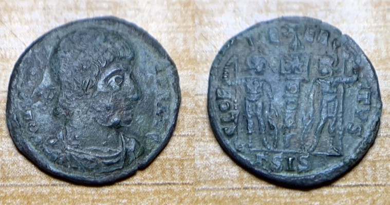 Constans/Gloria Exercitvs 346-348 AD.
AE17, 1.3 g. Obverse: CONSTAN S PF AVG. Laureate and rosette diademed, draped and cuirassed. Reverse: GLORIA EXERCITVS. 2 soldiers standing facing each other, resting hand on shield, 1 standard between them, Chi-rho on banner. Exergue: GammaSIS. RIC VIII Siscia 88.
