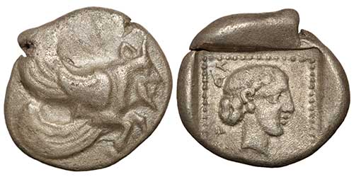 A silver diobol of Uvug, Dynast of Lycia, showing a winged, man-headed bull protome and a female head